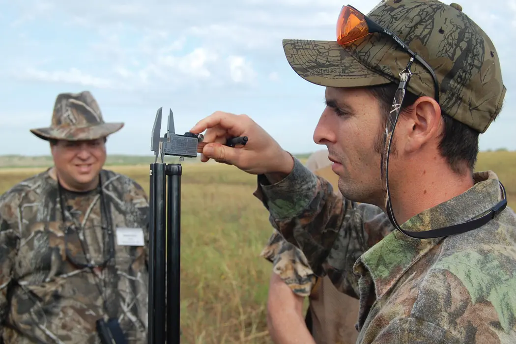 man measuring gun hole