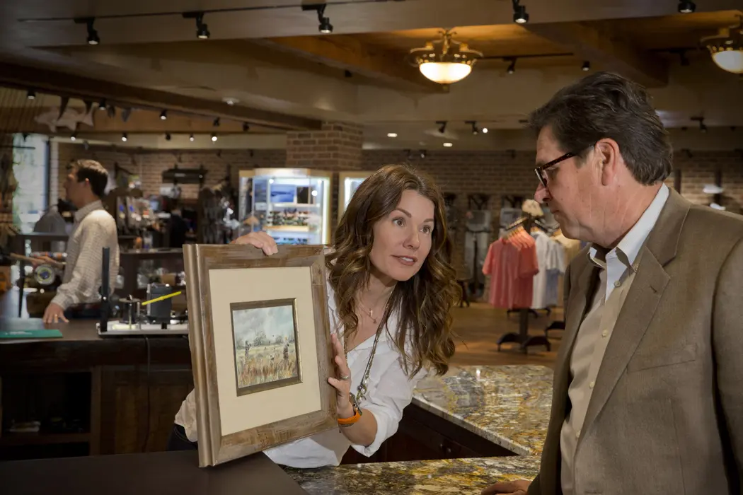 woman showing man painting Gordy & Sons