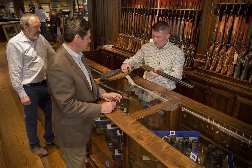 man looking at gun