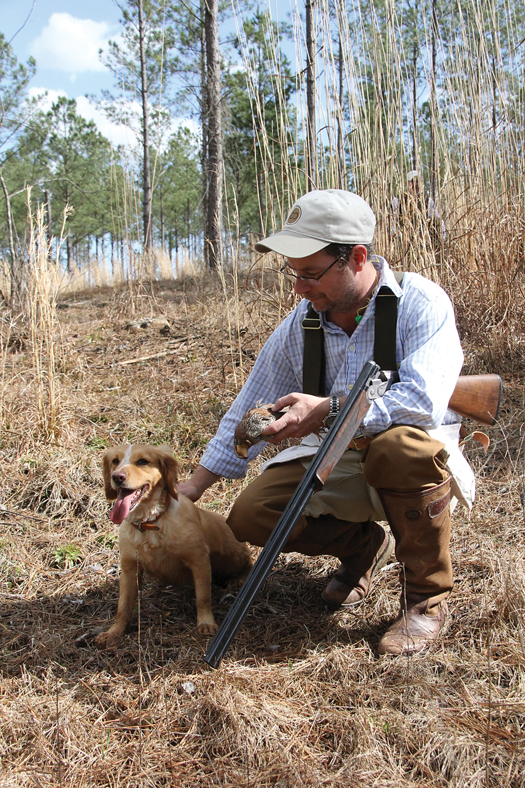man patting hunting dog