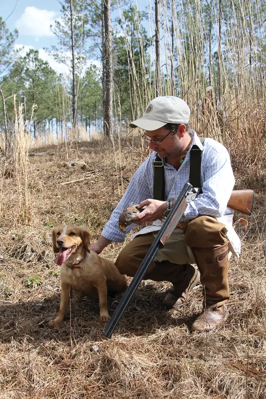 man patting hunting dog