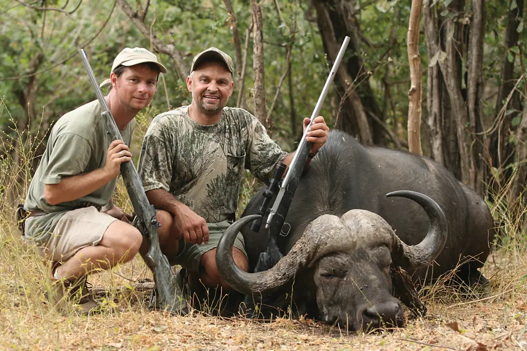 two men posing with hunt