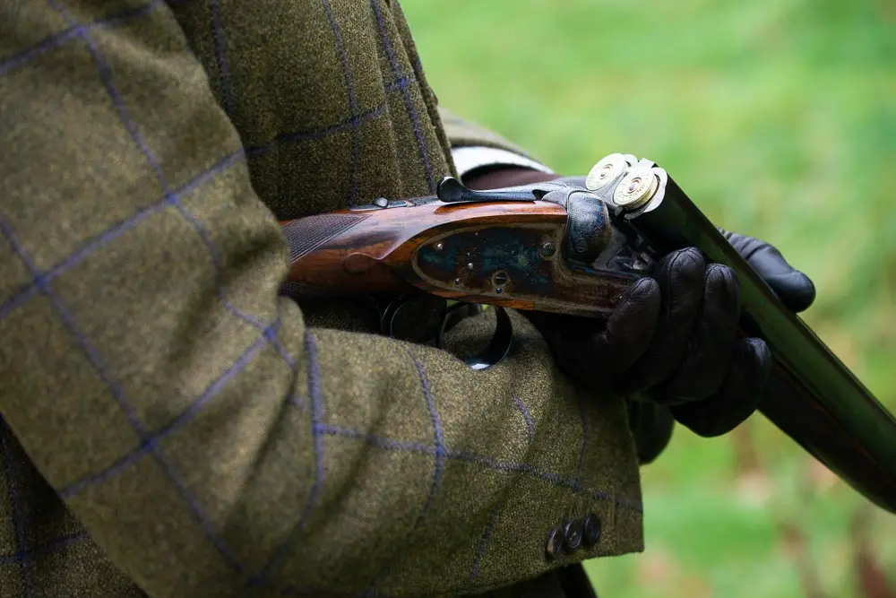 man cradling gun