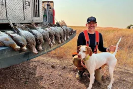 Man with dog and several birds they hunted