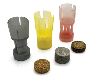 Collapsing cushioning posts in one-piece plastic wads and compressing fiber