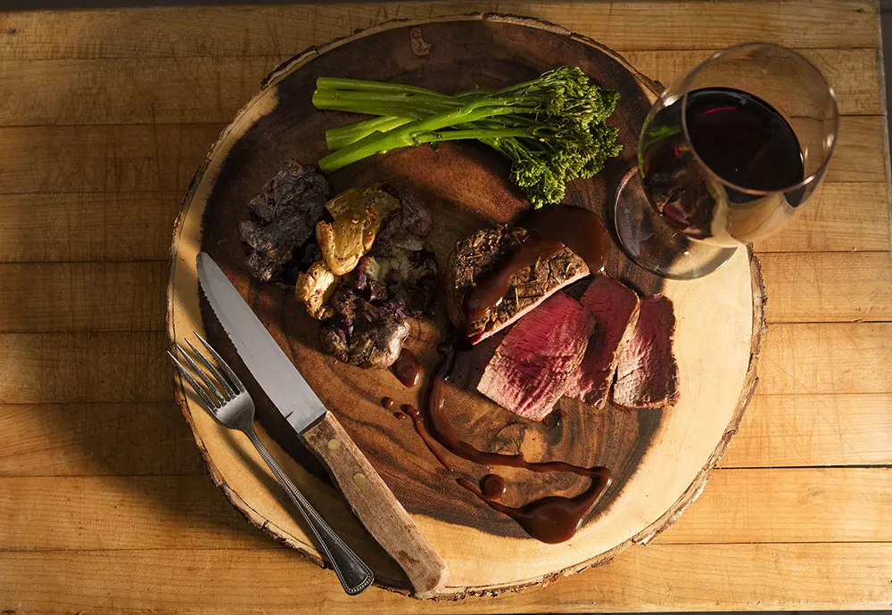 Steak and wine served at the Signature Lodge in South Dakota