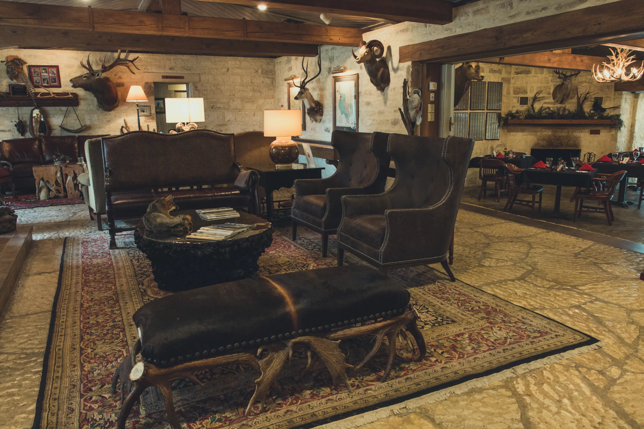 Luxury sitting area with leather couches and chairs at Joshua Creek Ranch